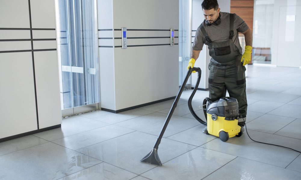 full-shot-man-vacuuming-office-floor