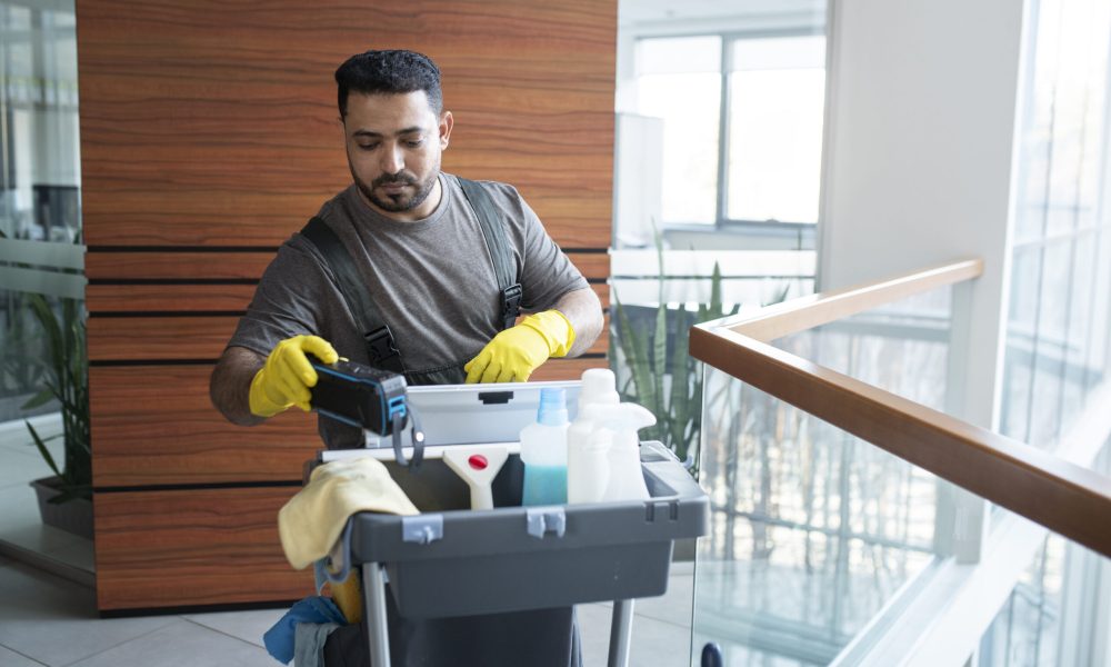 medium-shot-man-walking-with-cleaning-cart