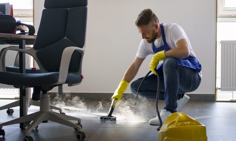 professional-cleaning-service-person-using-steam-cleaner-office